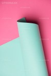 유토이미지 | close-up view of rolled turquoise paper on pink background