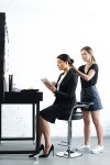 유토이미지 | side view of hairstylist doing hairstyle while businesswoman in suit using digital tablet