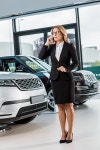 유토이미지 | businesswoman in formal wear talking on smartphone in dealership salon