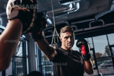 유토이미지 | handsome boxer exercising with trainer in gym