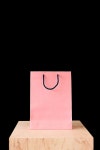 pink shopping bag on wooden tabletop isolated on black | 유토이미지 | 상세페이지 | 베이직샵 | 사진 | 21209967