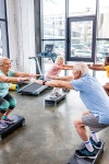 cheerful senior multiethnic sportspeople synchronous doing squats on step platforms at gym | 유토이미지 | 상세페이지... 