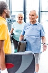 유토이미지 | male senior sportsmen with step platforms talking to each other at gym