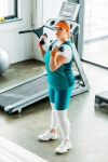 유토이미지 | overhead view of confident plus size woman training with dumbbells