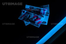 유토이미지 | blue ultraviolet lightning on russian money on black