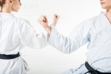 유토이미지 | cropped image of karate fighters showing block with hands isolated on white
