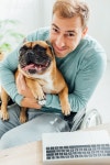유토이미지 | Disabled man holding french bulldog and smiling at camera
