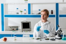 유토이미지 | biologist holding test tube and looking away in lab
