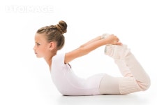 유토이미지 | side view of focused little ballerina stretching isolated on white