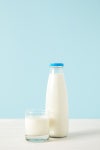 closeup view of bottle of milk and milk glass on blue background | 유토이미지 | 상세페이지 | 베이직샵 | 사진 | 21326300