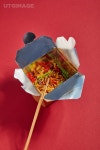 유토이미지 | top view of wooden chopsticks near tasty noodles with vegetables in takeaway box on red