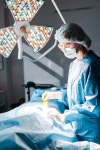 유토이미지 | nurse in uniform and medical cap holding strip in operating room