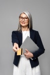 유토이미지 | smiling asian businesswoman with grey hair shopping online with credit card and laptop isolated on grey
