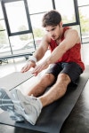 유토이미지 | selective focus of handsome sportsman stretching on fitness mat