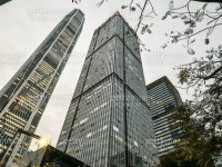 Close-up view of a modern Hong Kong buildings glass facade, reflecting the vibrant cityscape and sky. The contrasting blue and gold... 