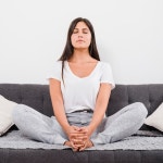 Premium Photo | Woman meditating at home