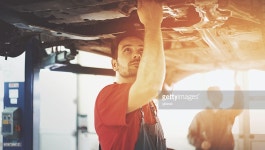 Car Service Stock Photo | Getty Images Closeup side view of early 30s mechanic working under a car. This is...