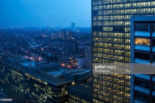 Working Late Stock Photo | Getty Images Modern glass building high above Brussels city skyline at night with...