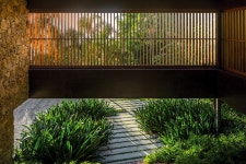 timber lattice with pivoting windows clads delta house by bernardes arquitetura in brazil