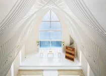 Slate-clad chapel boasts a veil-inspired ceiling structure