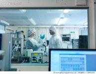 108442559 | 게티이미지코리아 | Scientists wearing protective clothing in a laboratory, look at a fusion target together Royalty... 