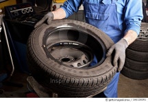 184128391 | 게티이미지코리아 | Mechanical repairs a tire in the garage Royalty-Free 이미지