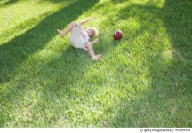 451494369 | 게티이미지코리아 | Young boy playing with a football outdoors at park Royalty-Free 이미지