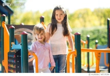 487176384 | 게티이미지코리아 | Smiling little girls enjoying at jungle gym in the park. Royalty-Free 이미지