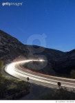 501264364 | 게티이미지코리아 | Vehicles circulating along a road with curves to the dusk, with the flushed lights Royalty-Free... 