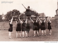 MARYEV16015921 | 게티이미지코리아 | Eight girls hold aloft ninth on gym bench posing with hoop Rights-Managed 이미지