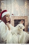626577432 | 게티이미지코리아 | Young beautiful woman with dog in a Christmas setting Royalty-Free 이미지