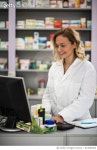 814956404 | 게티이미지코리아 | Happy mid adult pharmacist working on desktop PC in a pharmacy. Royalty-Free 이미지