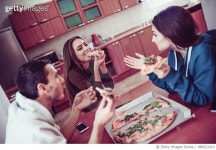 888521010 | 게티이미지코리아 | Group of Smiling Roommates Friends Sharing a Pizza at Home Royalty-Free 이미지