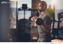 909416522 | 게티이미지코리아 | Active senior man having strength exercise with barbell in a gym. Royalty-Free 이미지