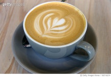 920718274 | 게티이미지코리아 | Flat white coffee in a gray cup on a bleached pine wood cafe table Royalty-Free 이미지