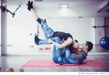 926007362 | 게티이미지코리아 | Attractive Couple Doing Yoga Pilates Tag Fitness Balance Exercise in Gym Royalty-Free 이미지