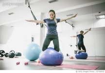 957500652 | 게티이미지코리아 | Young Female Doing Balance Pilates Exercise on Fitness Ball in Gym Royalty-Free 이미지