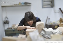 960209548 | 게티이미지코리아 | Young Female Sculptor is working in her studio Royalty-Free 이미지