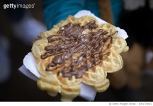 와플마레(Waffle mare) | 1091739932 | 게티이미지코리아 | Child holding a waffle with melted chocolate from a street food market Royalty-Free 이미지