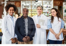 1128239095 | 게티이미지코리아 | Chemists standing with customer at drugstore Royalty-Free 이미지