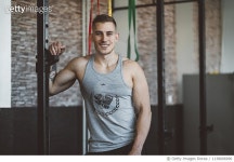 1138006996 | 게티이미지코리아 | A young athlete leaning and smiling in a gym Royalty-Free 이미지