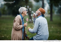 1179772680 | 게티이미지코리아 | Playful senior couple blowing bubbles from bubble wand at the park. Royalty-Free 이미지