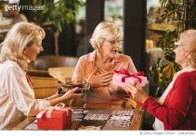 1184381664 | 게티이미지코리아 | Senior ladies celebrating birthday in cafe with cake and gifts Royalty-Free 이미지