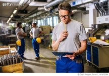 1203032388 | 게티이미지코리아 | Male manual worker looking at tablet PC inside metal factory Royalty-Free 이미지