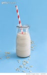 1203859512 | 게티이미지코리아 | Studio shot of bottle of milk with striped straw on blue background Royalty-Free 이미지