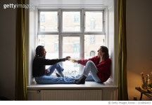 1214892433 | 게티이미지코리아 | Young female roommates toasting cocktails in apartment window Royalty-Free 이미지