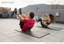 1214342263 | 게티이미지코리아 | mature man and young woman Doing crunches with sportswear on the terrace of his house at sunset... 