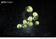1249352151 | 게티이미지코리아 | Green tomatoes flying in mid air with water splashing sync in high speed Royalty-Free 이미지