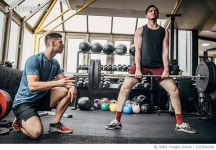 1253684184 | 게티이미지코리아 | Personal trainer training man with weights in the gym Royalty-Free 이미지