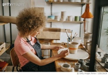 1256130139 | 게티이미지코리아 | Artist painting concrete flower pot in her studio Royalty-Free 이미지
